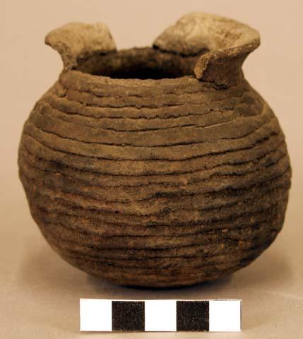 Ceramic jar, coiled, flared rim, sherds missing.