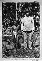 Full grown Philippines Negrito man next to Mr. Worcester; Bataan