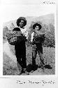 Two boys carrying baskets