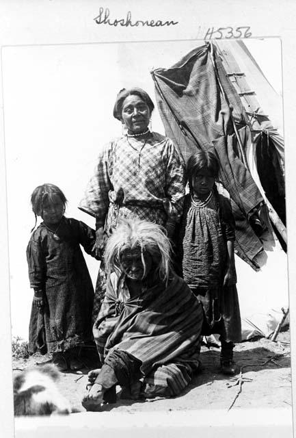 Women and girls at teepee entrance