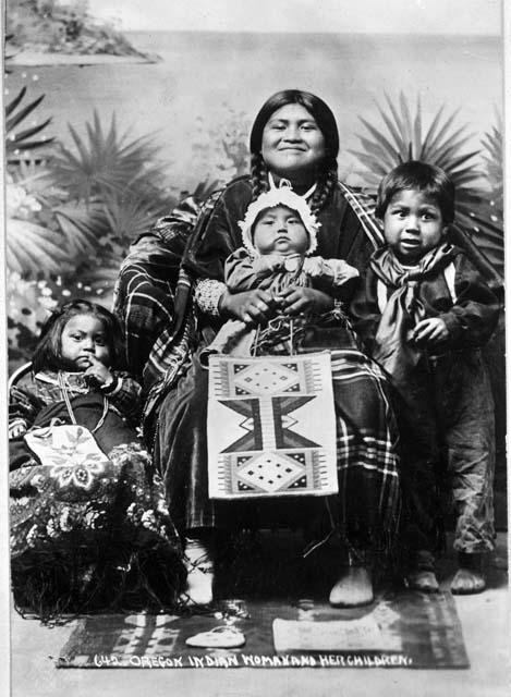 Women seated for portrait with her children