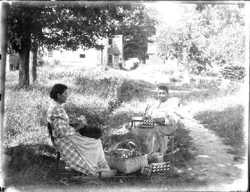 Two women weaving baskets. Copy Photo of N914.