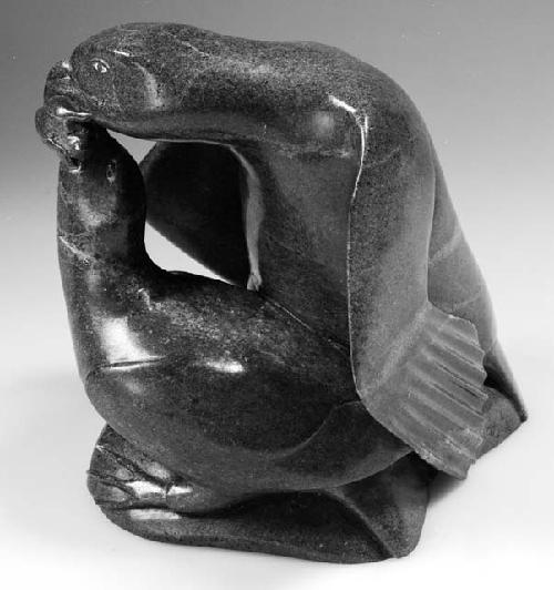 Photograph of soapstone carving of two aquatic birds (mother feeding baby) by joshua sheeg, ca