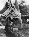 Man wearing feathered headdress for ceremonial dance