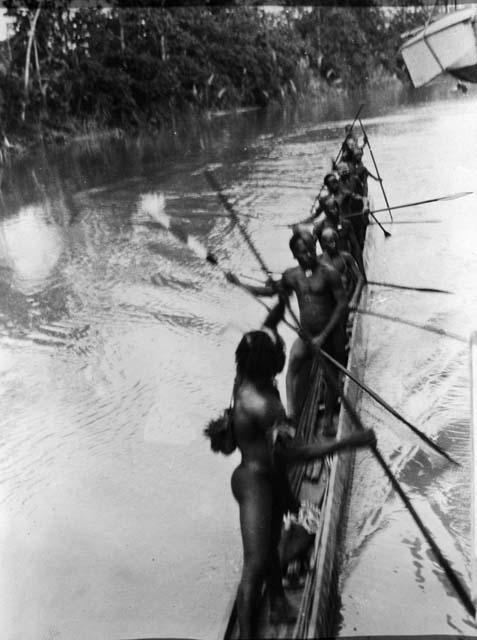 Copy negative of Long canoe paddled by 10 or 15 natives