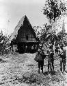Men in front of native house