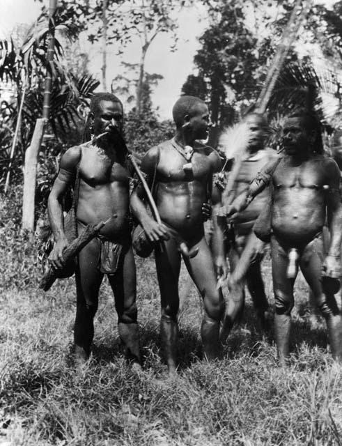 Men wearing penis sheaths of gourd and bamboo