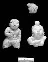 Moulded pottery figurine, male; ditto female with hand over breast