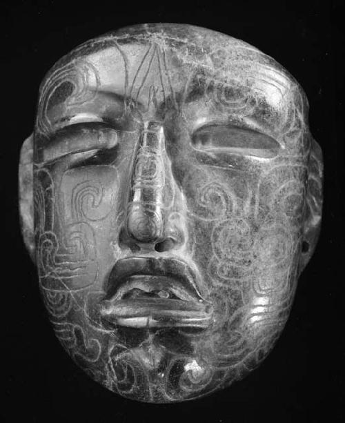 incised green stone mask