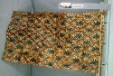 Tapa cloth with scalloped edge, black and brown flower-like designs