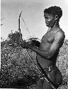 "/Qui Hunter" holding a bow and arrow, showing method of holding and releasing