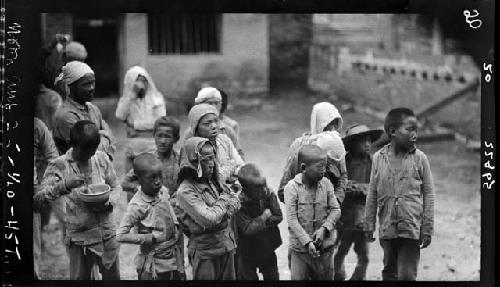 Group of children stands outside