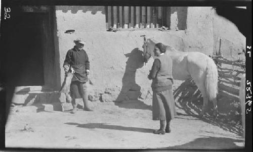 Ho, Janet Wulsin and horse stand outside building