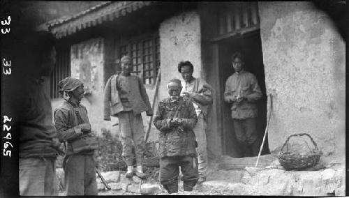 Men stand outside building