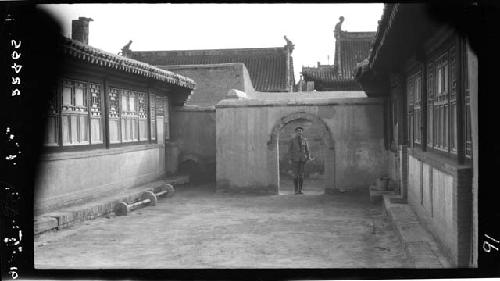 Man standing in gate of courtyard