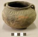 Ceramic vessel, flared lip, two handles, impressed design around rim.