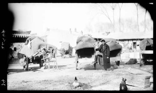 People and wagons in road