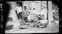 Men stand next to animal head and skin on cart