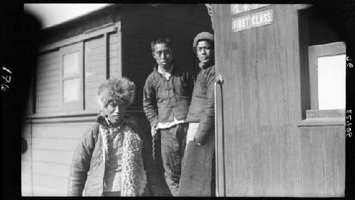 Three men outside building