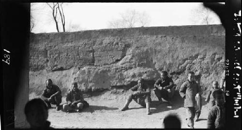 Men and boys seated outside