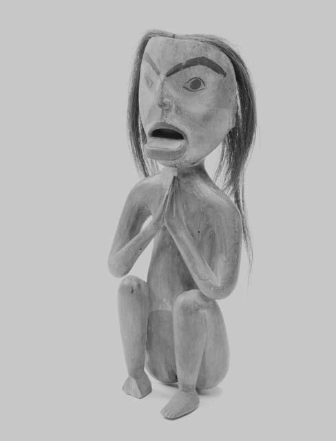 Wooden effigy of woman with labret
