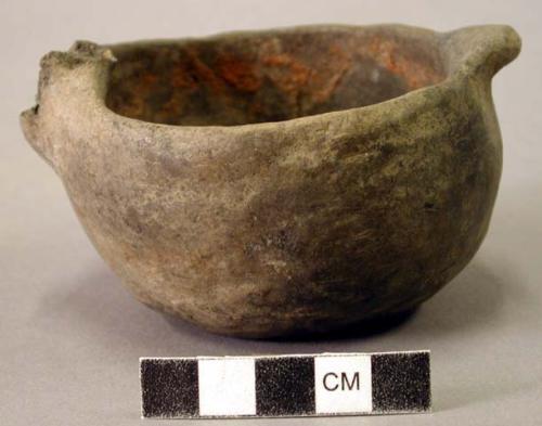 Ceramic vessel, effigy head or handle broken off.