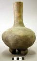 Ceramic vessel, long neck, flared, 3 rounded feet.