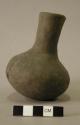 Ceramic vessel with long neck.