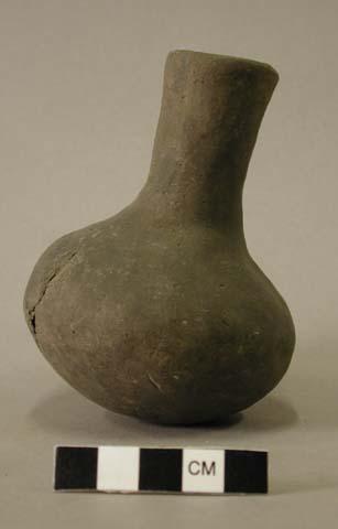 Ceramic vessel with long neck.