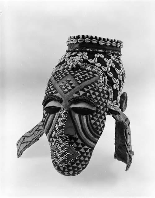 Painted ceremonial mask with beads and cowries