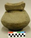 Cast, complete vessel, castelated rim, incised design.