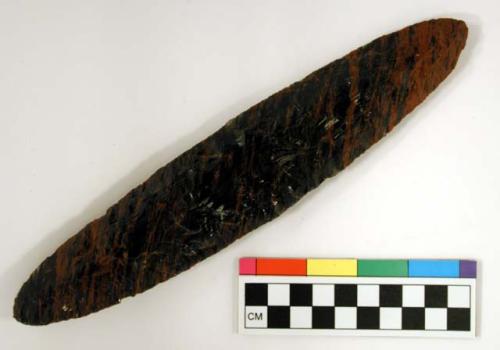 Chipped implement; chipped from red and black mottled obsidian