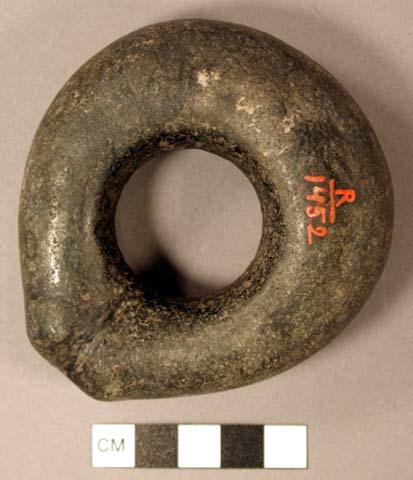 Ground stone object, perforated, possible net sinker.