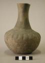 Ceramic complete vessel, long slim flared neck with ridge at base, indented desi
