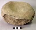 Ground stone mortar.