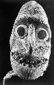 Close up of head of bark cloth anthropomorphic figure