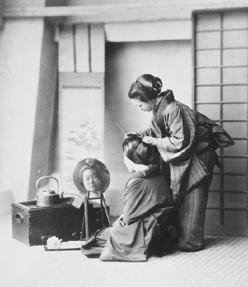 Woman styling other woman's hair