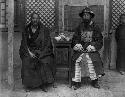 The postmaster (right) in his official regalia with one of the head lamas
