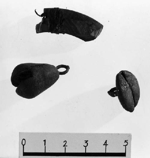 A shell ornament, a copper "button" bell and a copper pear shaped bell.