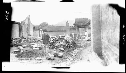 Man stands among ruins