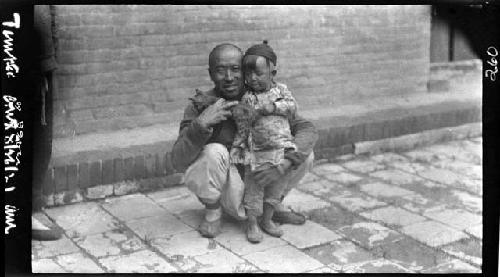 Man and child, holding cat