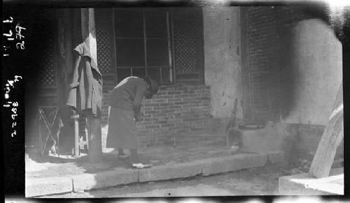 Janet Wulsin stands examining something in hands