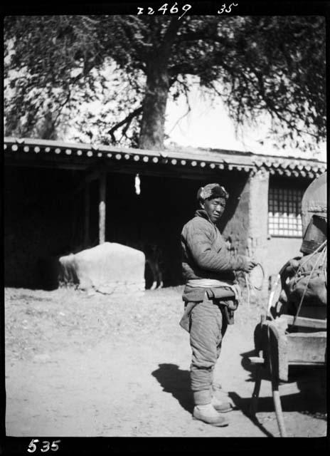 Man standing next to cart