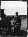 Man stands next to wagon