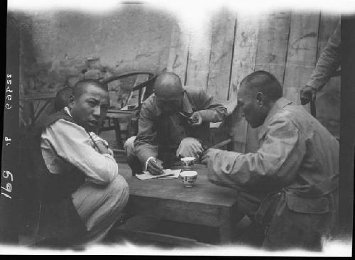 Men sitting around table