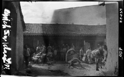 People and carts gathered in courtyard