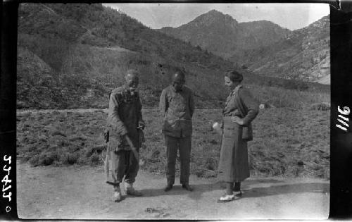 Two men and women standing in road