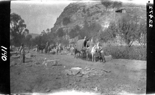 Group travels road in front of mountain