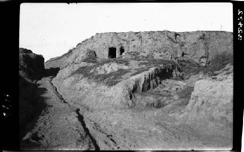 Landscape; earthen structure with door?