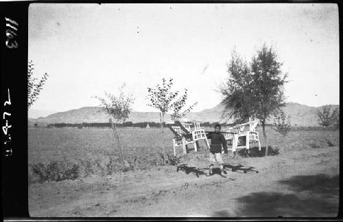 Boy carrying chairs